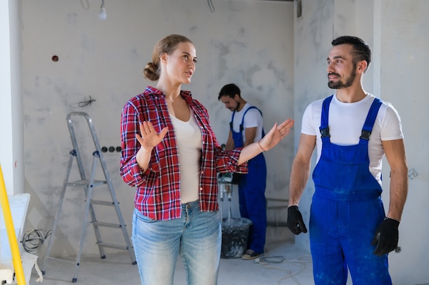 female customer talks male worker about renovation her apartment she shows where make repairs 225094 579